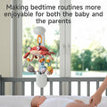 A baby lying in a crib looking up at a plush sea animal mobile with a red crab and ocean-themed characters. The mobile is attached to the crib and plays soothing music, creating a calming bedtime environment that helps both baby and parents enjoy the bedtime routine.