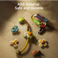 A dinosaur-themed bath toy set is displayed disassembled on a tiled surface. The set includes a dinosaur shower toy, colorful spiral track, floating submarine and narwhal toys, and suction cup flower toys with bee and ladybug designs. The text reads 
