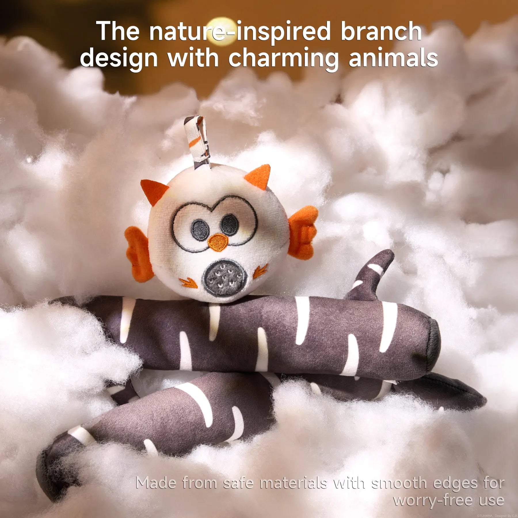 Plush fabric branches in black-and-white birch pattern nestled in soft white ‘clouds,’ topped by a round owl plush with orange accents, highlighting the mobile’s nature-inspired branch design with charming woodland animals.