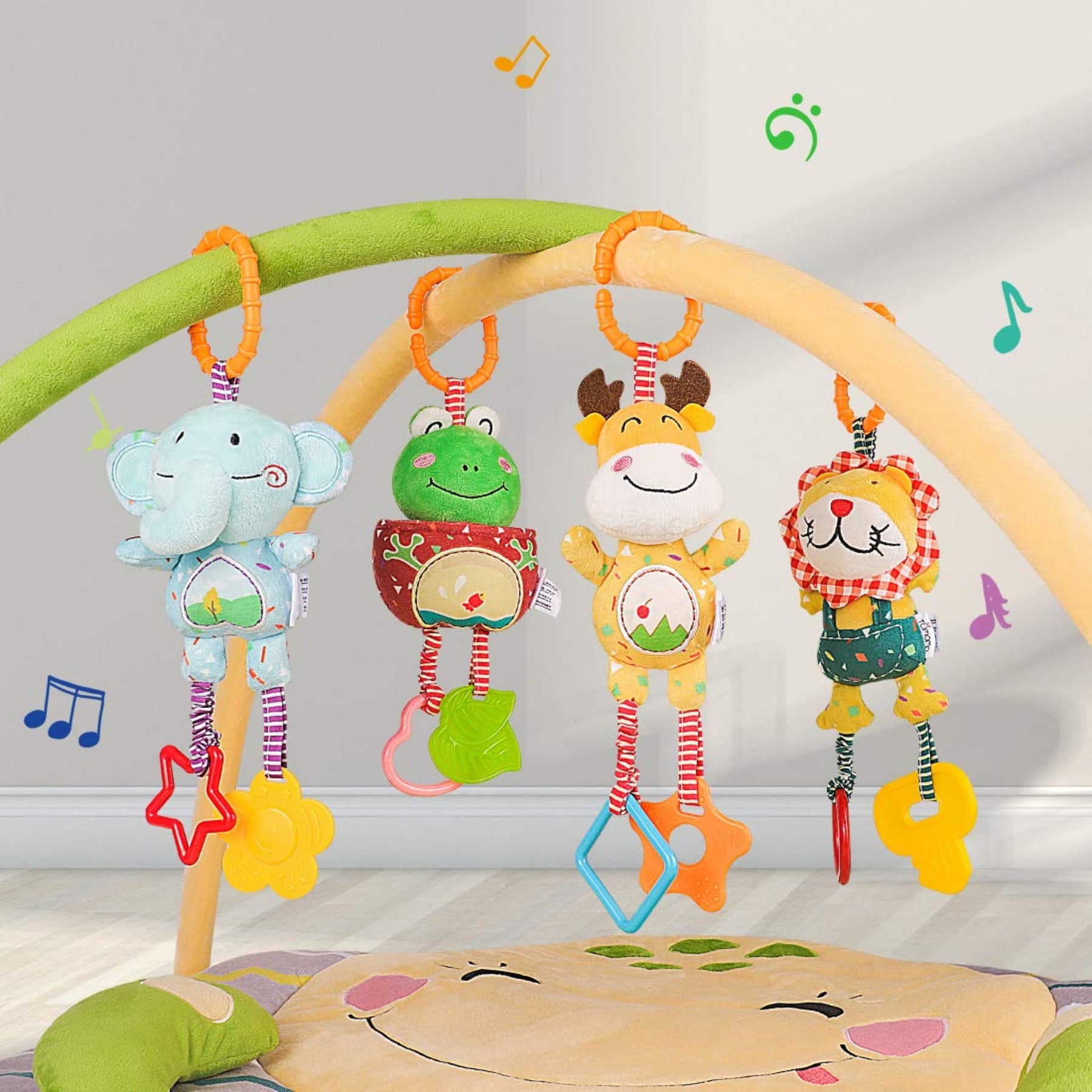 Four plush animal rattles—a blue elephant, green frog, yellow giraffe, and checked‑mane lion—hanging from soft pastel play gym arches with rings and dangling teether shapes.