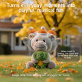 Interactive plush hippo and turtle toy sitting on grass surrounded by autumn leaves, swaying side to side with motion blur, promoting playful musical fun for kids.
