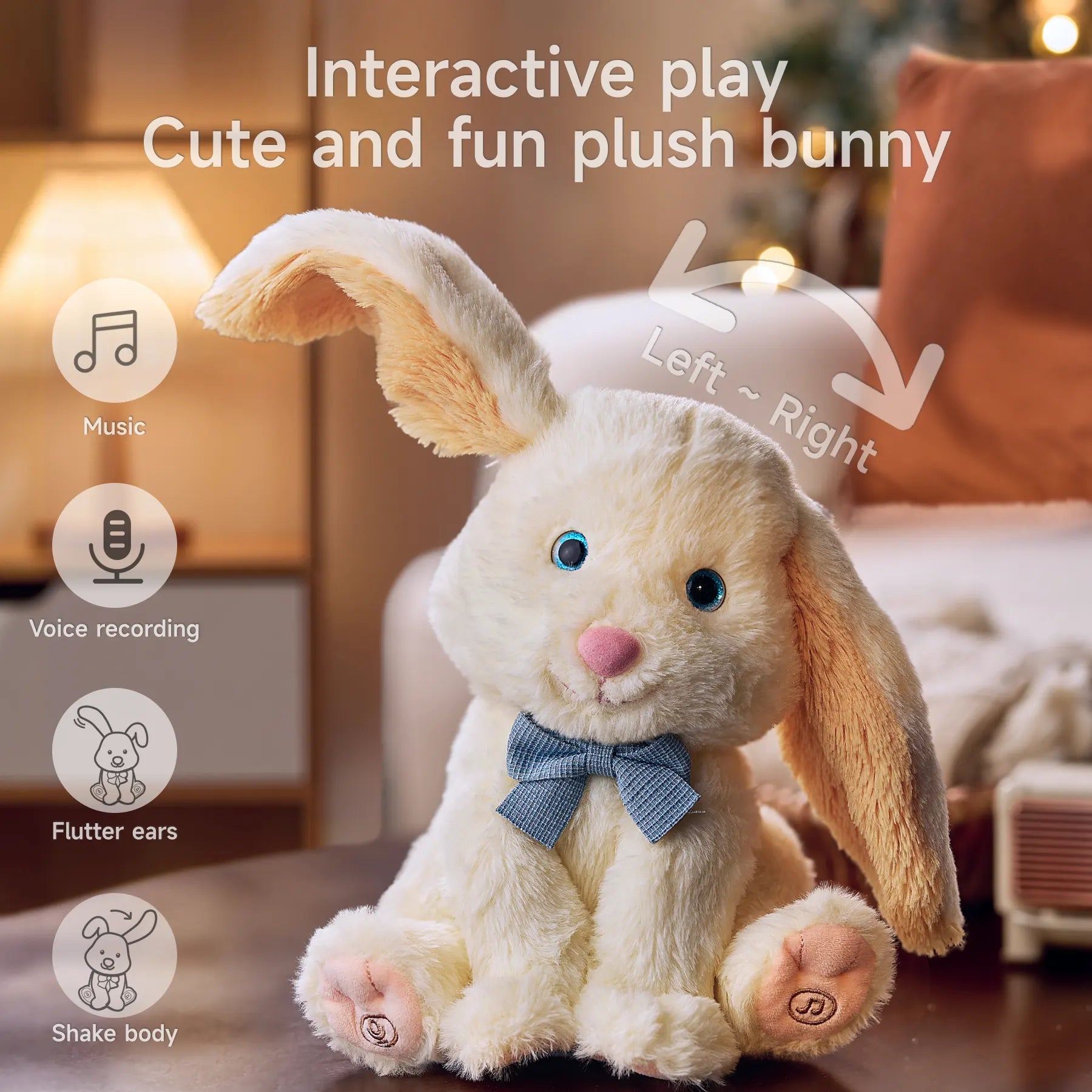 Interactive plush bunny toy sitting on a table with blue eyes and a blue bow tie, capable of playing music, voice recording, fluttering its ears, and shaking its body.