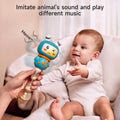 Smiling baby sitting on a couch and reaching out for a blue bunny-shaped musical rattle with teether ears. An adult hand holds the toy, which is making an animal sound with the text ‘Meow~’ and colorful motion lines, indicating sound and movement.