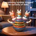 Musical stacking rings toy with spinning tumbler base and rotating colorful rings to engage babies