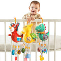 Newborn infant sensory play with baby dinosaur hanging toy