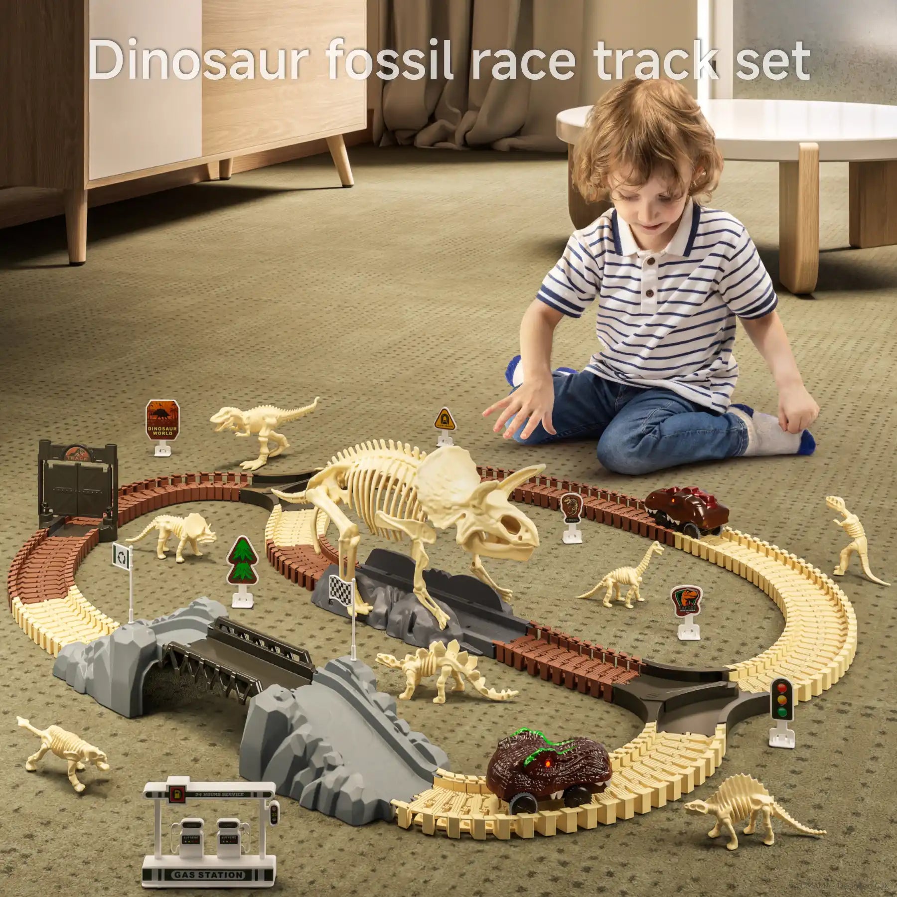 Young boy playing on the floor with a dinosaur fossil racetrack set that includes large skeletal dinosaur figures, two toy cars, bridges, signs, and fossil accessories on a beige carpet in a cozy indoor setting.